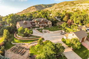 Aerial view of property and surrounding area with a mountain backdrop