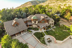 View of subject property featuring a mountain backdrop and a tree filled landscape
