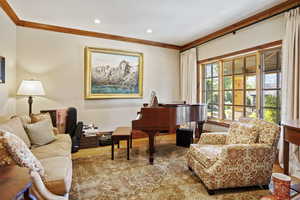Sitting room with ornamental molding, wood finished floors, and recessed lighting