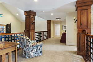 Living area featuring recessed lighting, light carpet, an upstairs landing, and baseboards