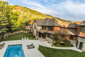 Swimming pool featuring a yard and a mountain view
