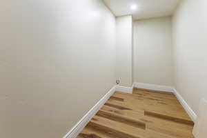 Unfurnished room with baseboards and light wood-style flooring