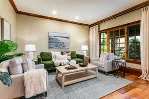 Living room featuring crown molding, wood finished floors, and recessed lighting