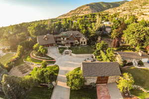 Aerial view of property and surrounding area with a mountainous background