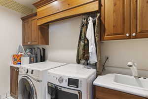 Laundry room featuring cabinet space and washer and dryer
