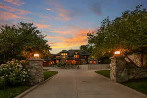 View of front facade featuring stone siding and concrete driveway