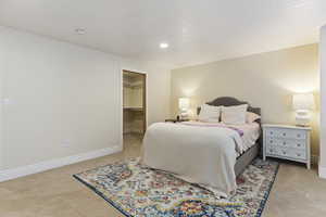 Bedroom with light carpet, baseboards, a spacious closet, recessed lighting, and a closet