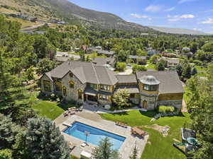 View from above of property with a pool area and a mountainous background