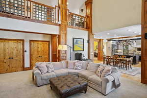 Living area with a high ceiling and recessed lighting