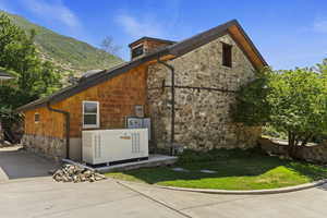 View of home's exterior with mail area, stone siding, and a mountain view