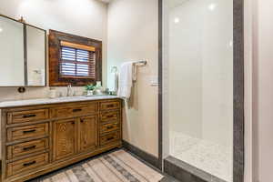 Bathroom featuring vanity and a walk in shower