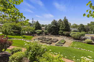 View of grassy yard with a garden