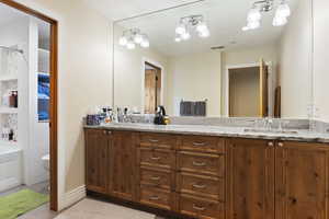 Bathroom with double vanity and toilet