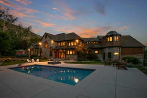 Pool at dusk with an outdoor pool and a patio area