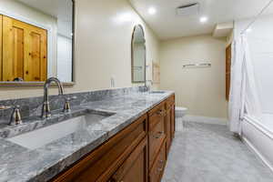 Bathroom with shower / bath combo with shower curtain and double vanity