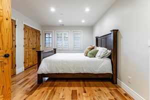 Bedroom with light wood-type flooring and recessed lighting