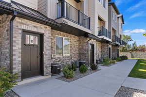 Property entrance with brick siding and stone siding