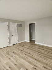Spare room featuring light wood-type flooring