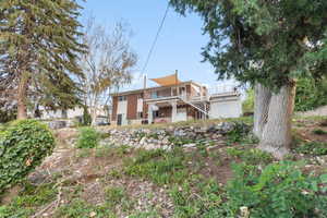 Rear view of house featuring stairs