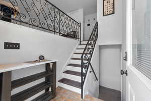 Staircase featuring a towering ceiling