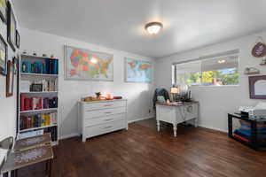 Office space with wood finished floors and baseboards