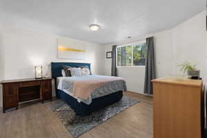 Bedroom featuring wood finished floors and a textured ceiling