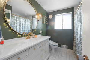 Bathroom with vanity, tile patterned floors, and a shower with shower curtain