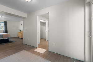 Bedroom with wood finished floors and a textured ceiling