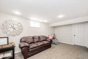 Living area with carpet flooring and recessed lighting