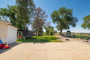View of patio / terrace with a playground and a trampoline