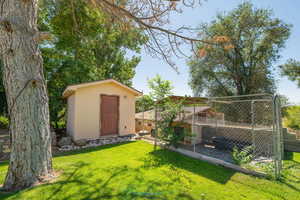 View of yard featuring a storage unit