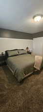 Carpeted bedroom with a textured ceiling