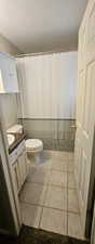 Bathroom with a textured ceiling, vanity, tile patterned floors, and a shower with curtain