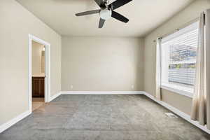 Empty room with carpet and a ceiling fan
