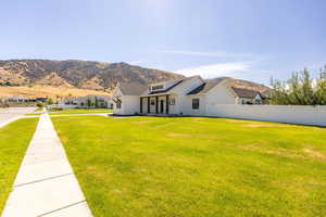 View of front of home with a mountain view, board and batten siding, and covered porch