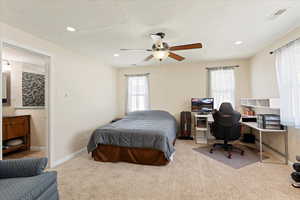 Bedroom featuring multiple windows, carpet, an office area, ceiling fan, and recessed lighting