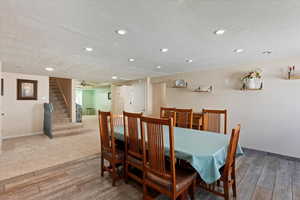 Dining space featuring a textured ceiling, wood-type flooring, stairs, recessed lighting, and ceiling fan