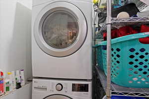 Laundry area featuring stacked washer / drying machine