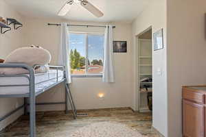 Bedroom with wood finished floors and a ceiling fan