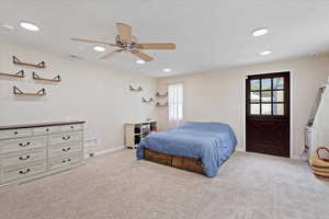 Bedroom featuring light carpet, a textured ceiling, recessed lighting, and a ceiling fan