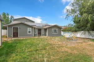 Rear view of property with solar panels