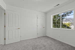 2nd floor bedroom with new paint, new carpet and a walk in closet