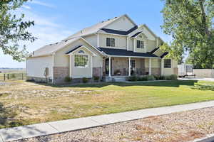 Craftsman-style home with brick siding, a porch, and a shingled roof