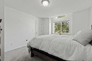 2nd floor bedroom with shelving and a walk in closet