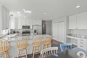 Kitchen with new stainless steel appliances, recessed lighting, white oak cabinets, and granite countertops