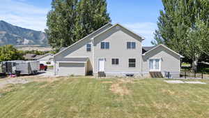 Rear view of property with entry steps and a mountain view