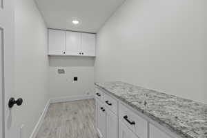 Basement Laundry room with custom cabinets and granite countertops.