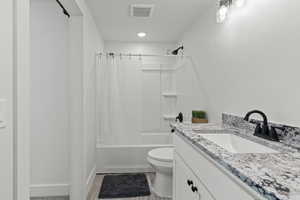 BASEMENT Full bath with shower / bath combination, granite countertops and custom cabinets with large side cabinet.