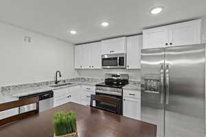 BASEMENT Kitchen with  NEW stainless steel appliances, recessed lighting, white cabinets, and granite countertops