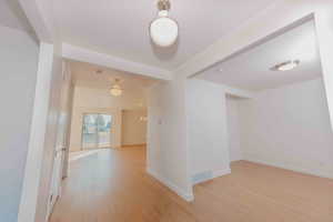 Spare room with light wood-style floors and baseboards